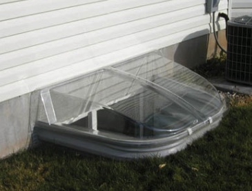 A plastic window well cover.